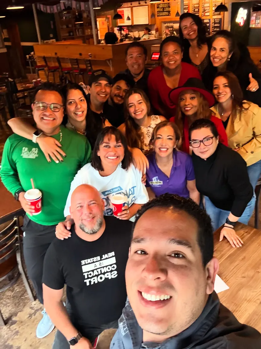 A group of people smiling in a group selfie inside Reformation Brewery